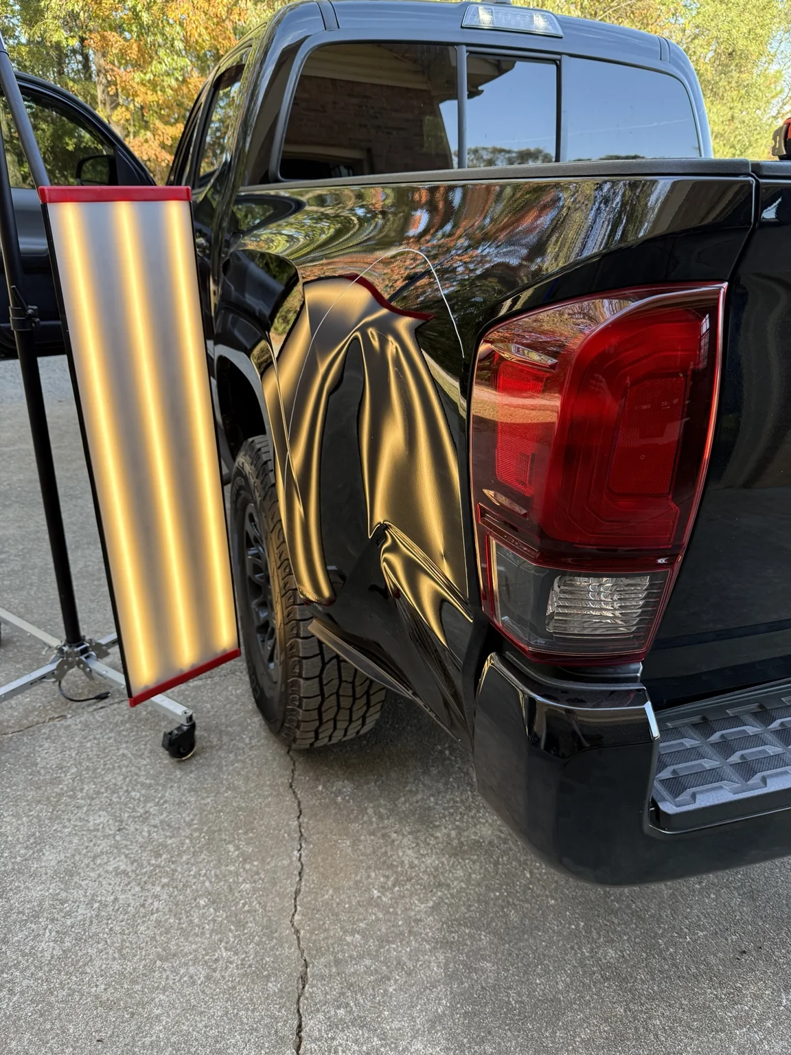 Severe truck bedside dent before paintless dent repair